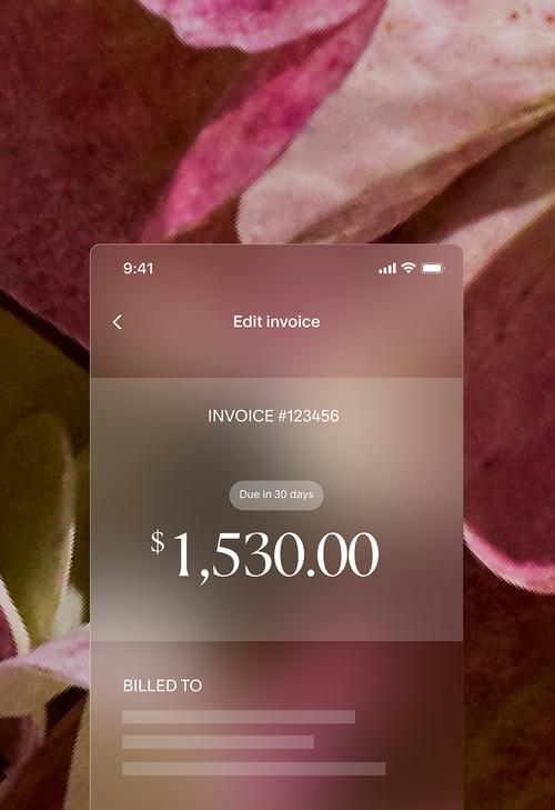 Invoice editing interface showing Invoice #123456 with an amount of $1,530.00 due in 30 days and billed-to information fields, displayed over a close-up background of pink hydrangea petals.